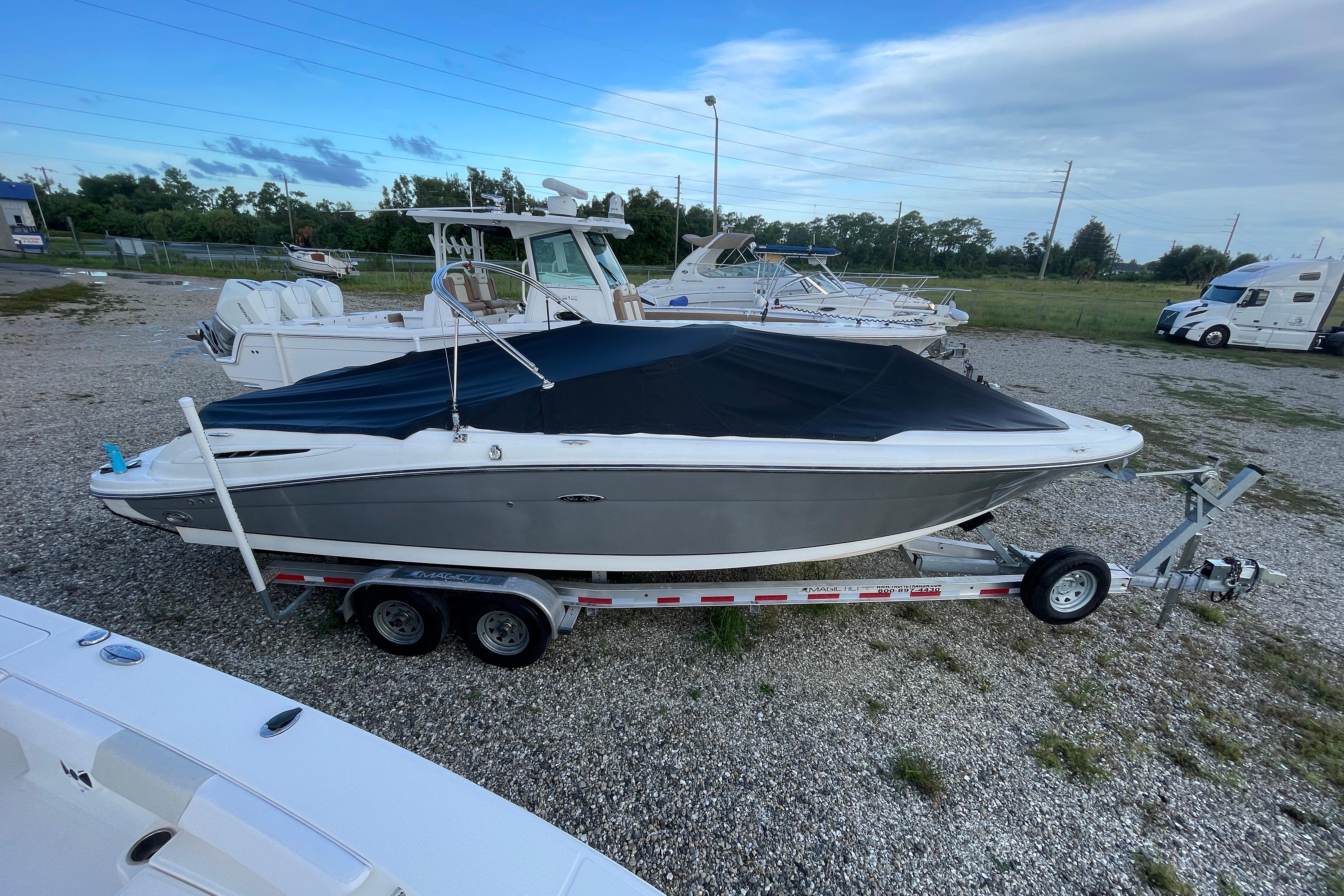 Sea Ray 270 SLX 2006 Sea Ray 270 SLX boat on trailer, covered, parked outdoors.
