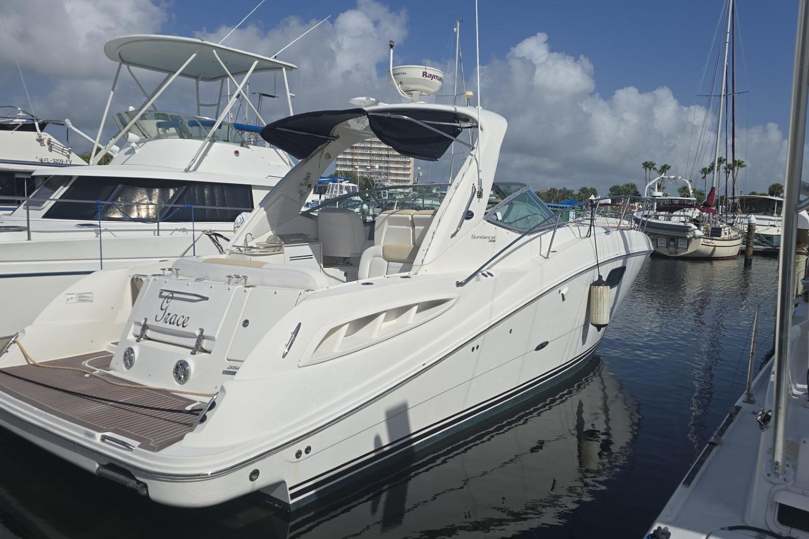 Sea Ray 350 Sundancer 2010 Sea Ray 350 Sundancer yacht docked in a marina under a clear blue sky.