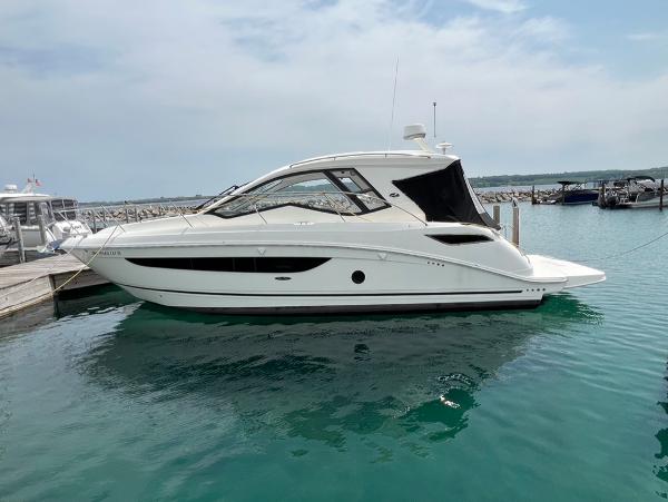 Sea Ray Sundancer 350 Coupe 2019 Sea Ray Sundancer 350 Coupe docked in a marina, calm waters, overcast sky.