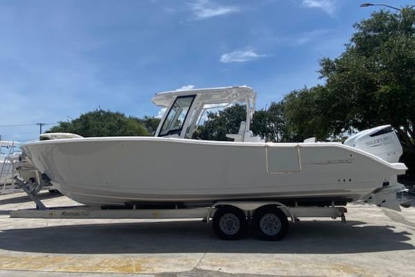 Aquasport 2800 AS 2025 Aquasport 2800 AS boat on trailer, parked outdoors under clear sky.