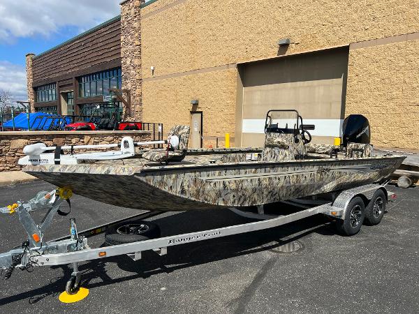 Ranger RB210 2024 Ranger RB210 boat on a trailer outside a building.