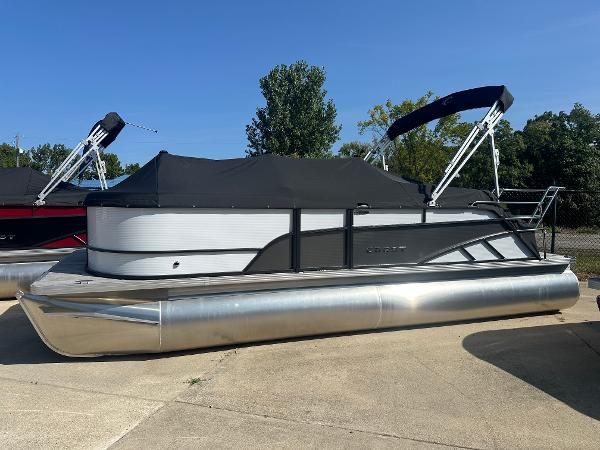 Crest Classic LX 220 SLSC 2024 Crest Classic LX 220 SLSC pontoon boat with black canopy, parked outdoors.