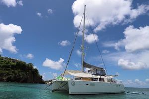 Lagoon 450 F 2012 Lagoon 450 F catamaran sailing in clear blue waters under a bright sky.
