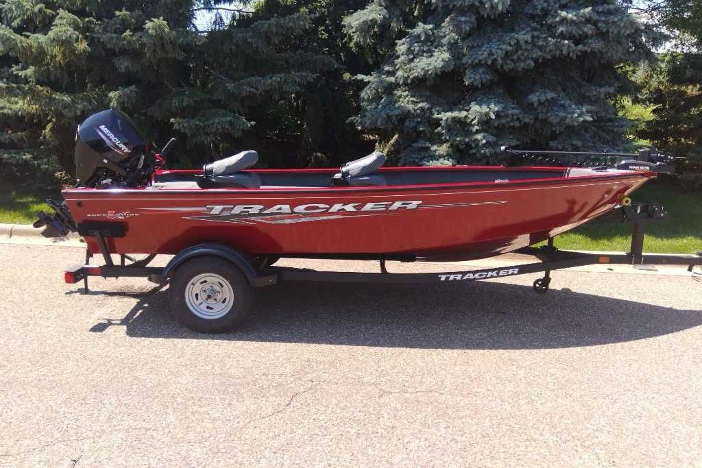Tracker Super Guide V-16 T 2025 Tracker Super Guide V-16 T boat on trailer, red color, parked outdoors.