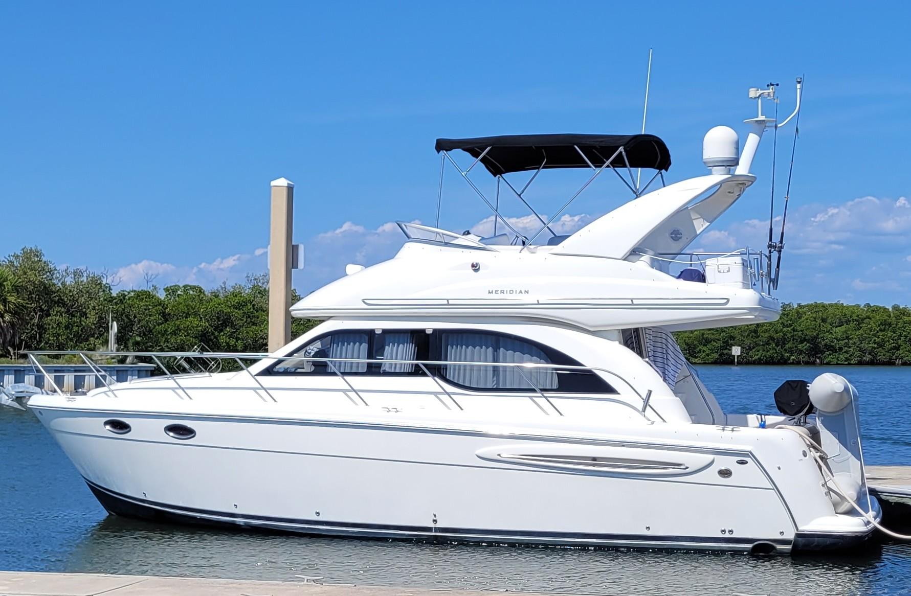 Meridian 341 Sedan 2004 Meridian 341 Sedan yacht docked on a sunny day, featuring sleek white design.
