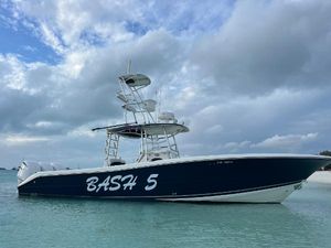Triton 351 CC 2006 Triton 351 CC boat named "Bash 5" on calm water under cloudy sky.
