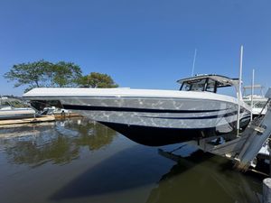 Fountain 38 SCX 2025 Fountain 38 SCX boat docked on a sunny day, reflecting on water.