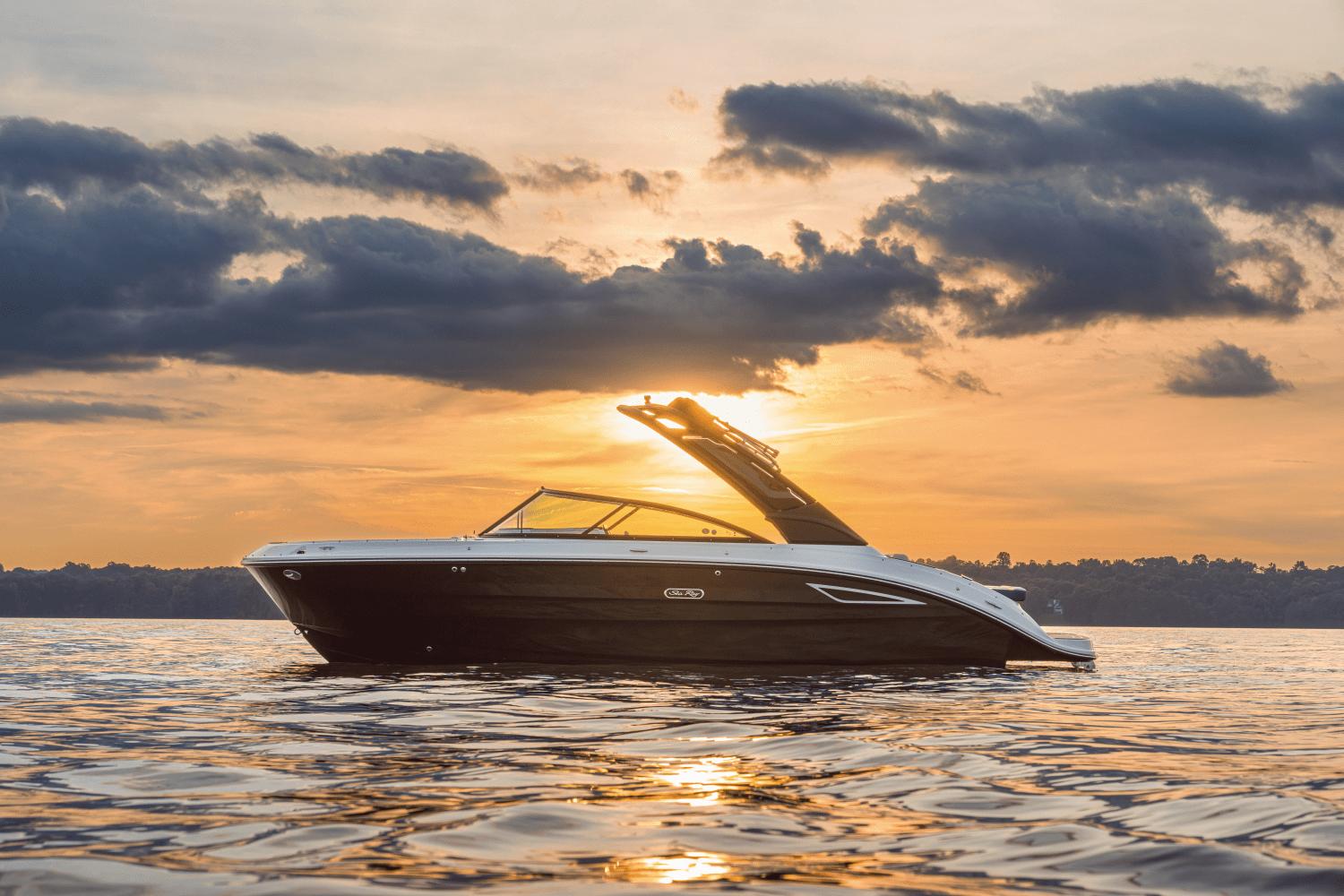 Sea Ray SDX 250 2025 Sea Ray 250 SDX boat on water at sunset, with dramatic clouds.