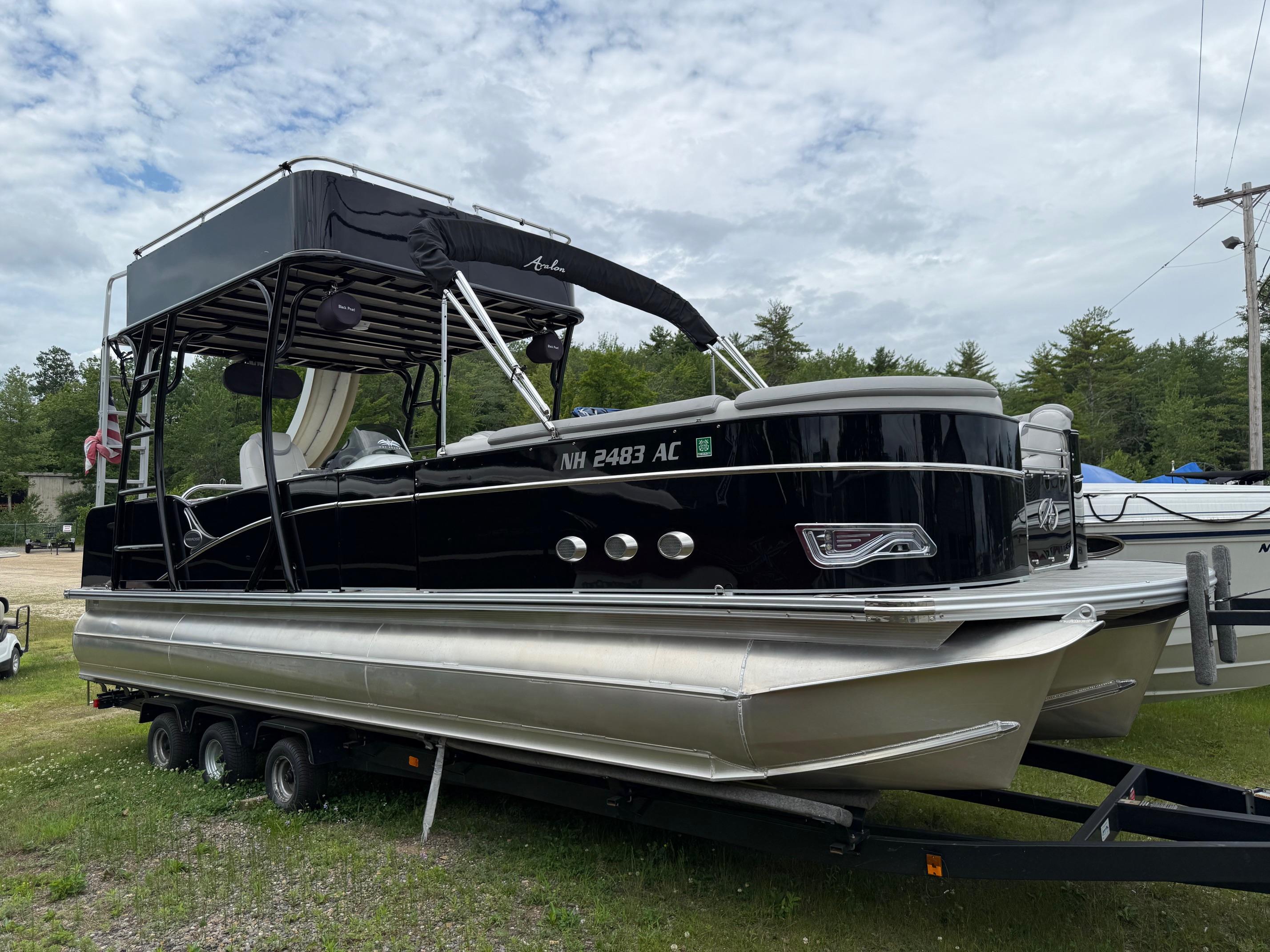 Avalon Paradise Funship - 27' 2015 Avalon Paradise Funship pontoon boat on trailer, parked outdoors.