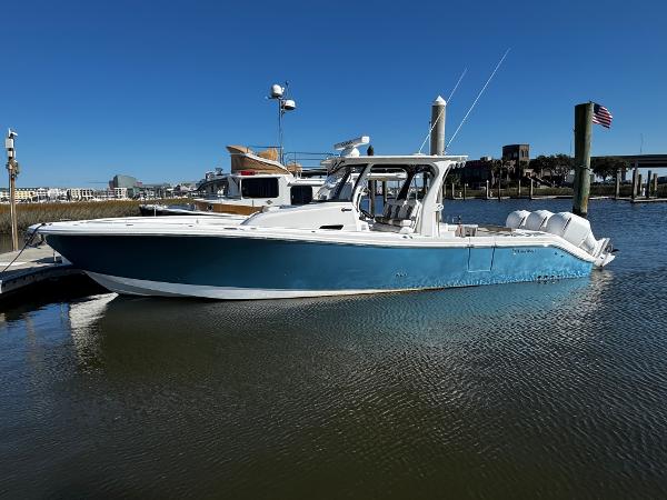 Edgewater 370CC 2020 Edgewater 370CC boat docked in a marina under clear blue skies.