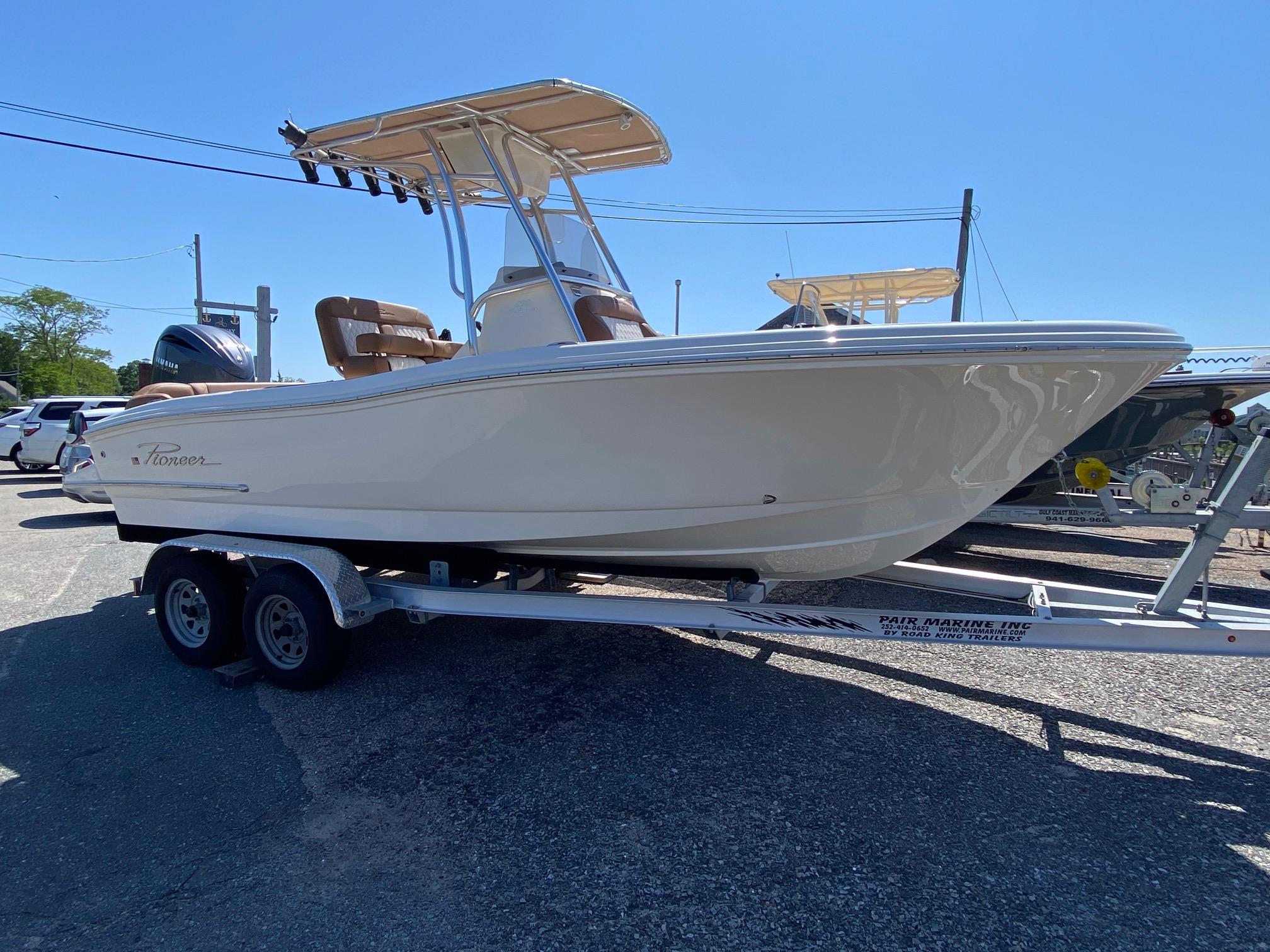 Pioneer 202 Islander 2025 Pioneer 202 Islander boat on trailer, parked outdoors under clear blue sky.