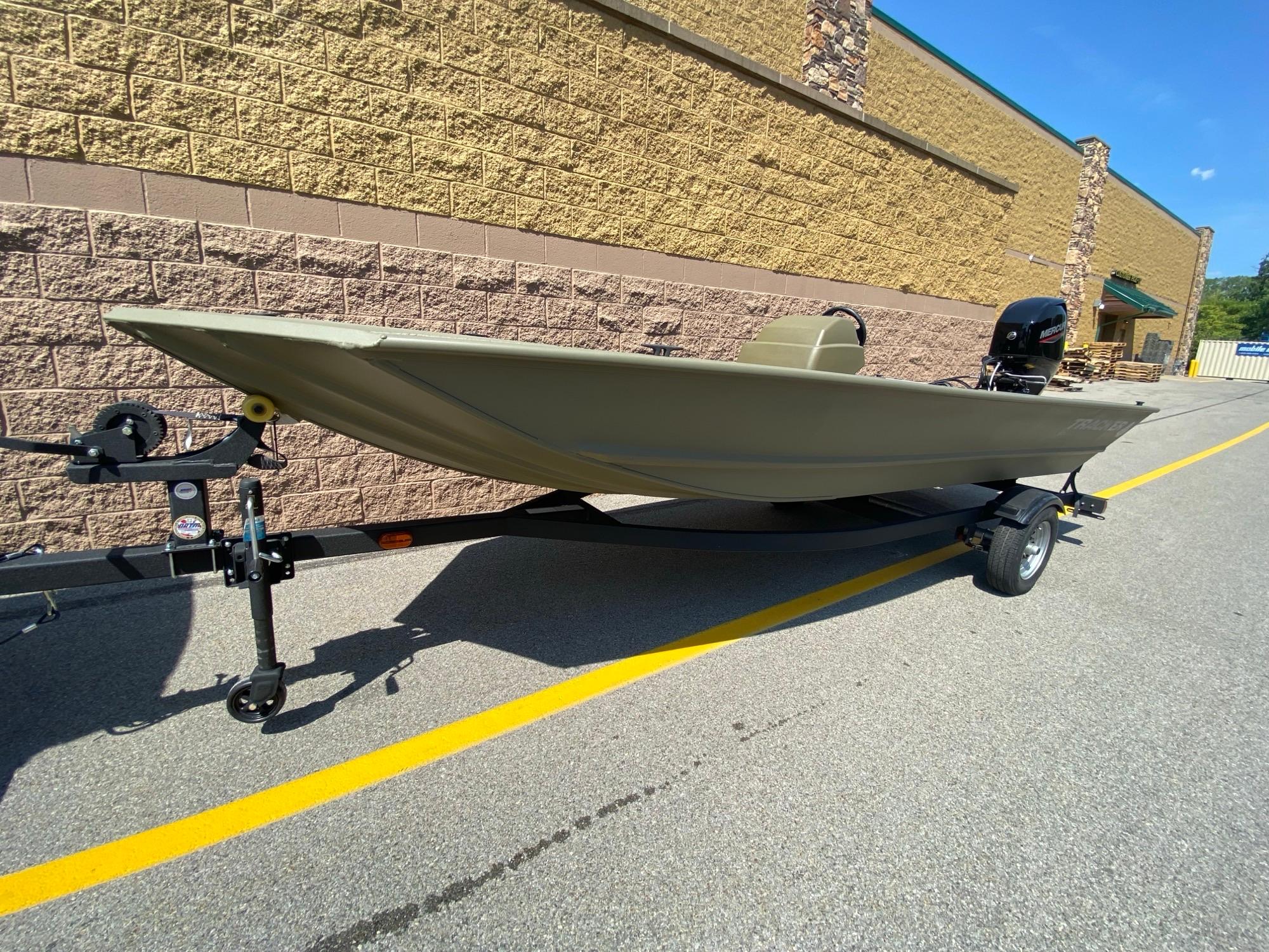 Tracker Grizzly 1648 SC 2024 Tracker Grizzly 1648 SC boat on trailer, parked outdoors.