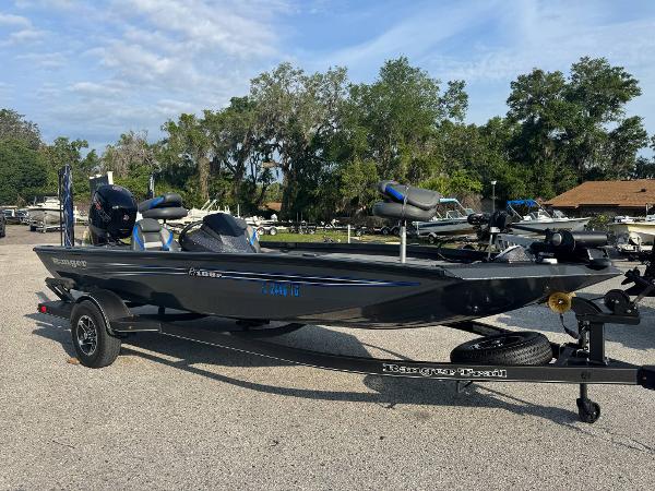 Ranger RT188P 2022 Ranger RT188P boat on trailer, parked outdoors with trees in background.