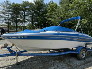 Four Winns 200 Horizon 2008 Four Winns 200 Horizon boat on trailer, blue cover, parked outdoors.