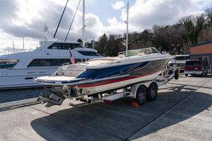 Chris-Craft Launch 27 2022 Chris-Craft Launch 27 boat on trailer, dockside with yachts in background.