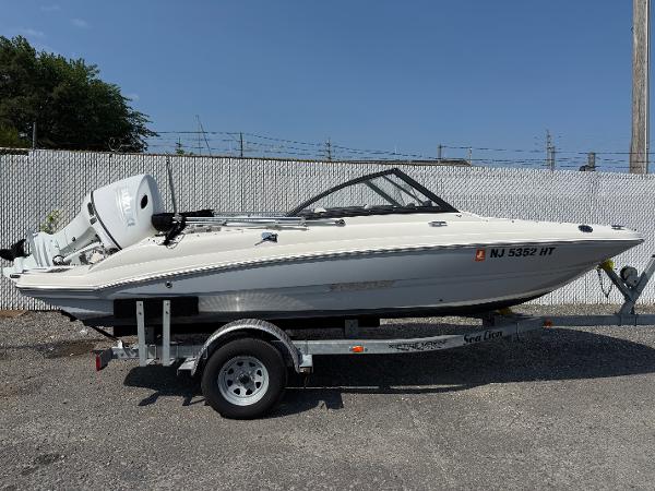 Stingray 191 DC 2023 Stingray 191 DC boat on trailer, side view, outdoors.