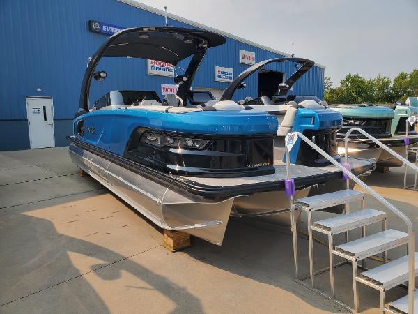 Avalon Excalibur Quad Lounge Windshield 2024 Avalon Excalibur Quad Lounge Windshield boat displayed at a dealership.