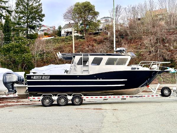 North River 3000 EXL 2025 North River 3000 EXL boat on a trailer, parked outdoors.