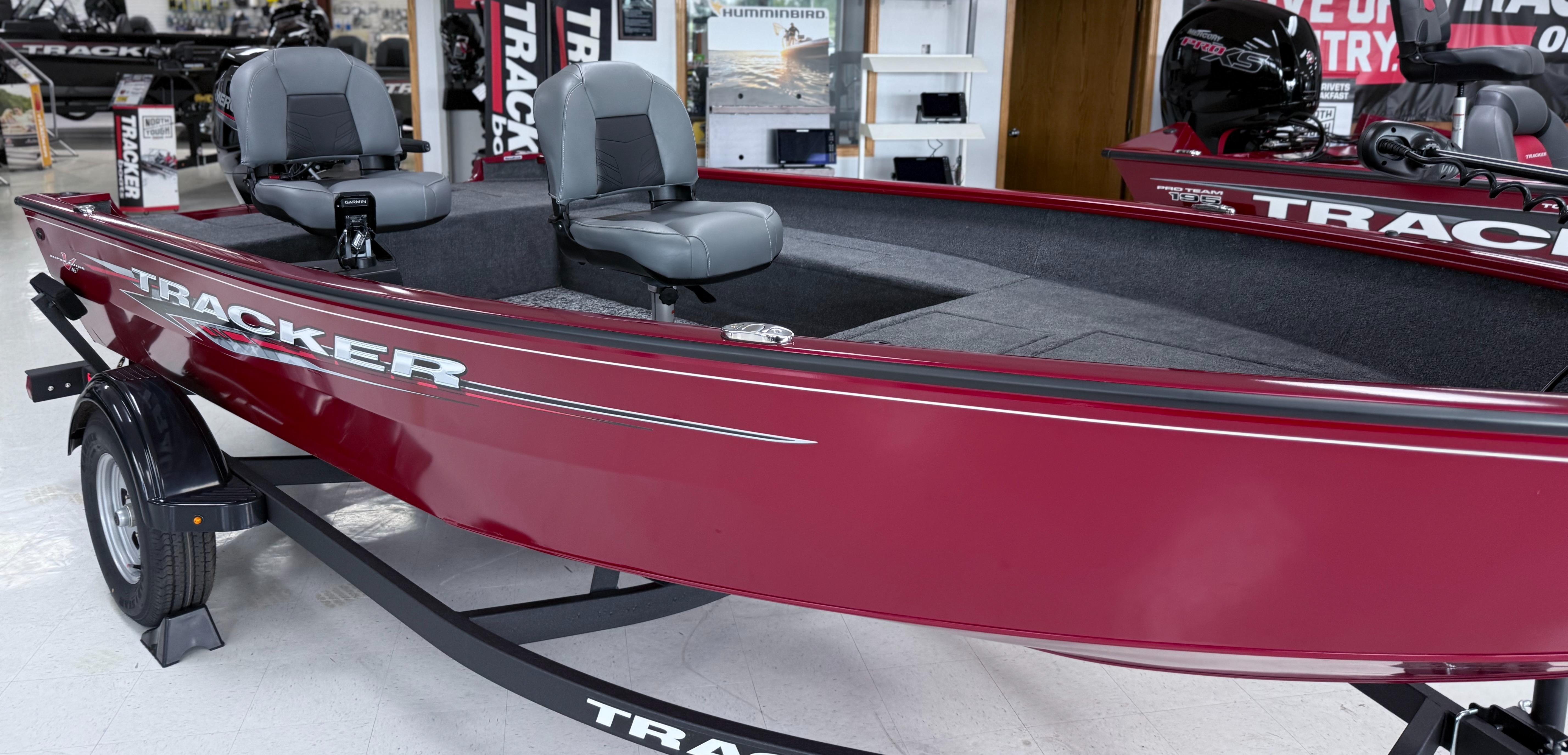 Tracker Super Guide V-16 T 2025 Tracker Super Guide V-16 T boat, red exterior, displayed in showroom.