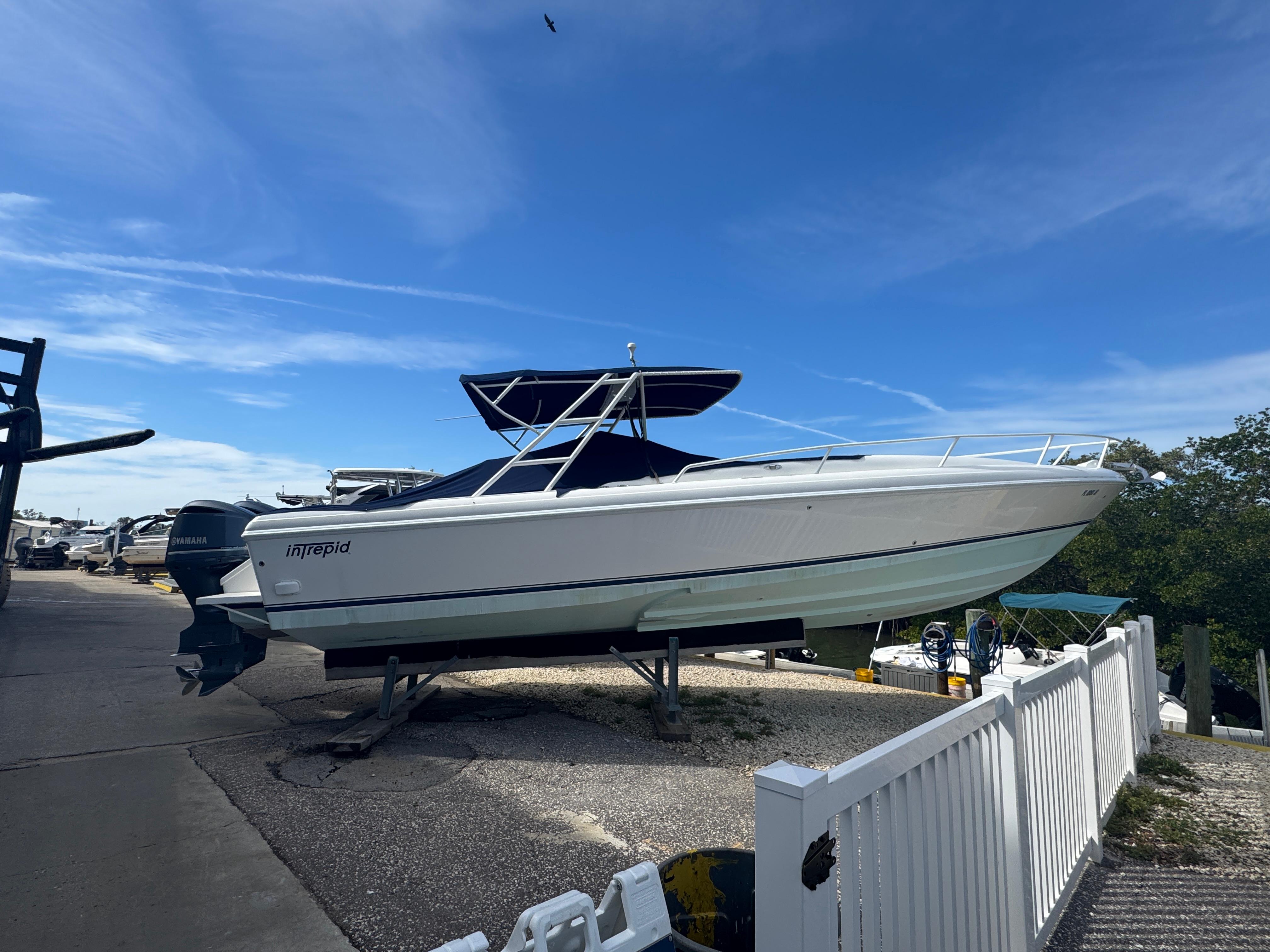 Intrepid 356 Cuddy 1996 Intrepid 356 Cuddy boat on dry dock under clear blue sky.