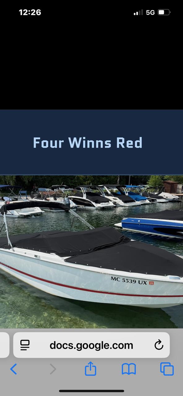 Four Winns H1 2024 Four Winns H1 boat docked in clear water, featuring a sleek design.