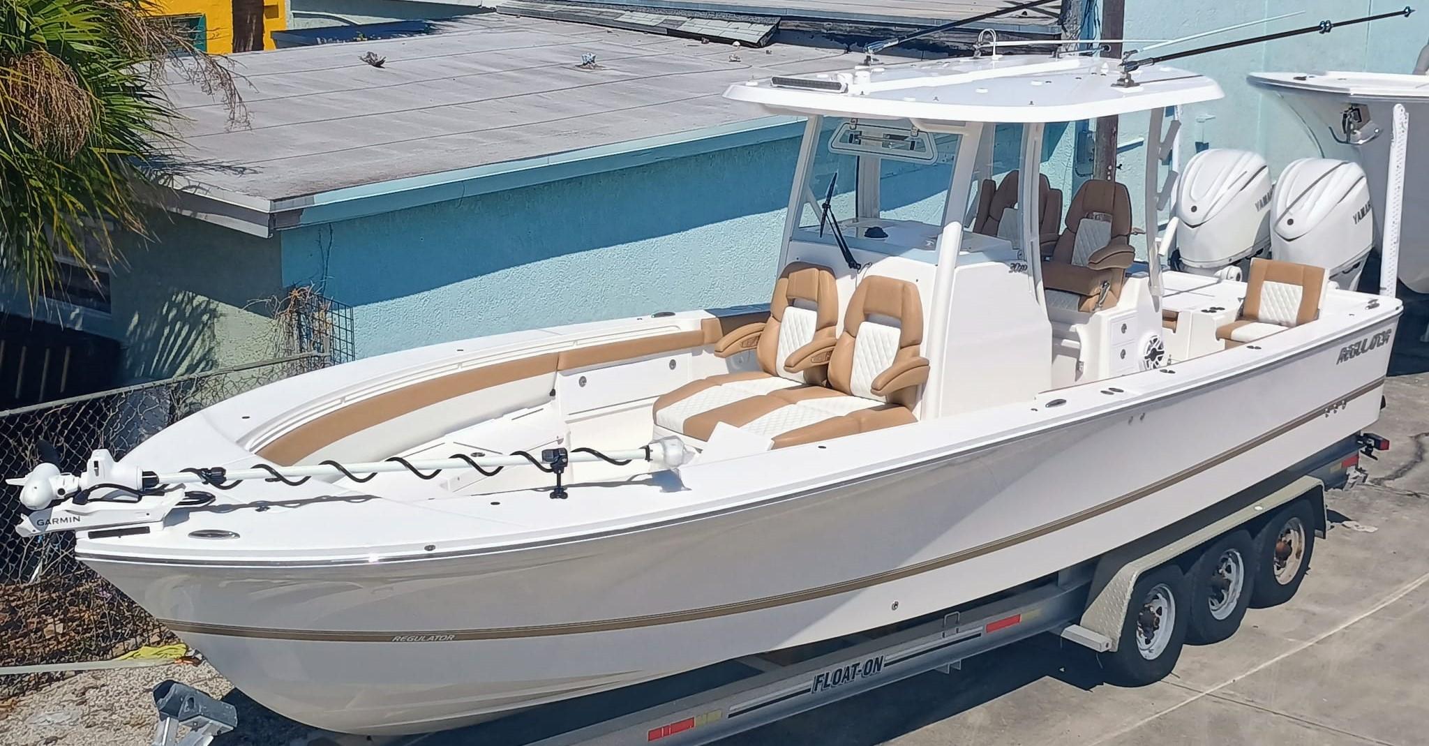 Regulator 30XO 2025 Regulator 30XO boat on trailer, featuring dual engines and luxurious seating.