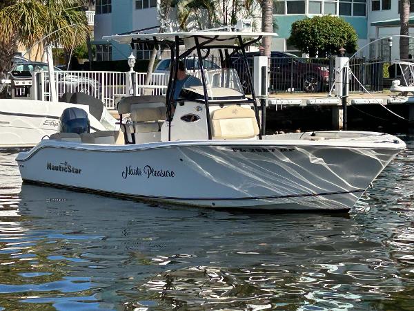 NauticStar 2302 Legacy 2018 NauticStar 2302 Legacy boat docked in a sunny marina setting.