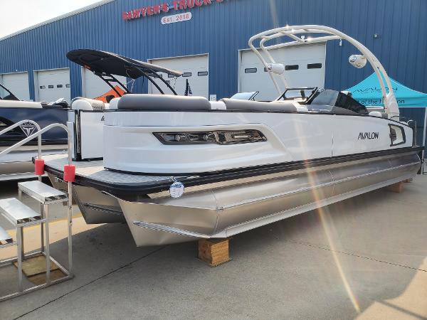 Avalon Excalibur LTD Quad Lounge Windshield 2024 Avalon Excalibur LTD Quad Lounge Windshield pontoon boat on display.
