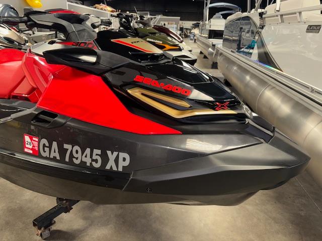 Sea-Doo RXT-X300 2019 Sea-Doo RXTX jet ski in showroom, red and black design, side view.