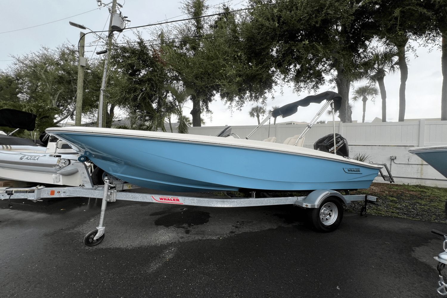 Boston Whaler 160 Super Sport 2025 Boston Whaler 160 Super Sport boat on trailer, blue hull, parked outdoors.