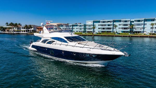 Azimut 62 EVOLUTION FLY Azimut 62 Evolution Fly 2010 yacht cruising on a sunny day near waterfront buildings.