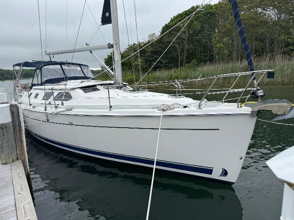 Hunter 41 Deck Salon 2006 Hunter 41 Deck Salon sailboat docked in a serene marina setting.