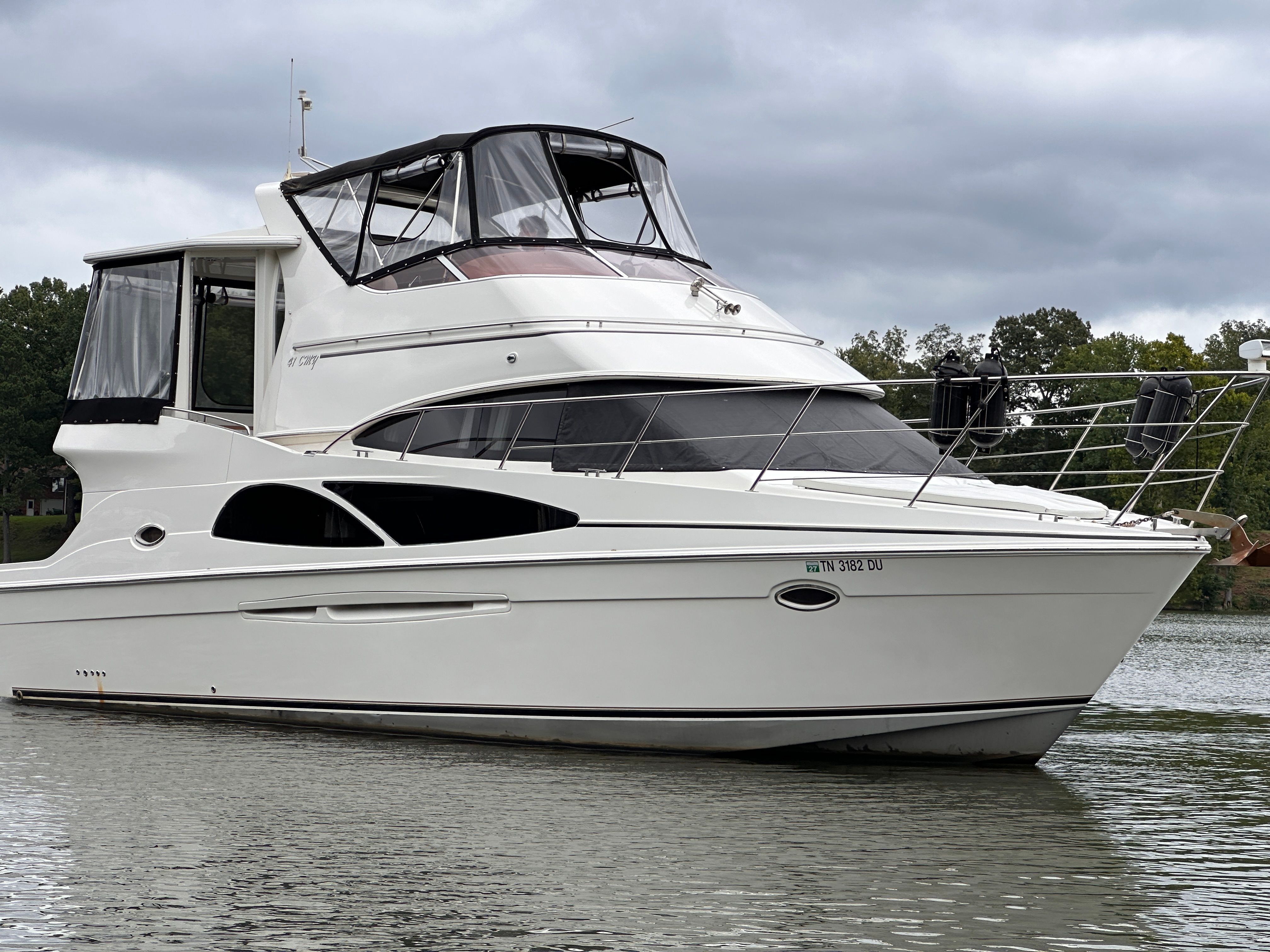 Carver 41 Cockpit Motor Yacht 2006 Carver 41 Cockpit Motor Yacht on calm water under cloudy skies.