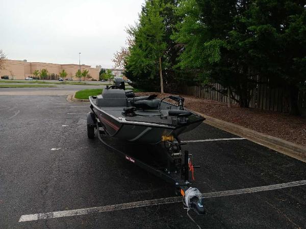Tracker Bass Tracker Classic XL 2024 Tracker Bass Tracker Classic XL boat parked in a lot, surrounded by trees.