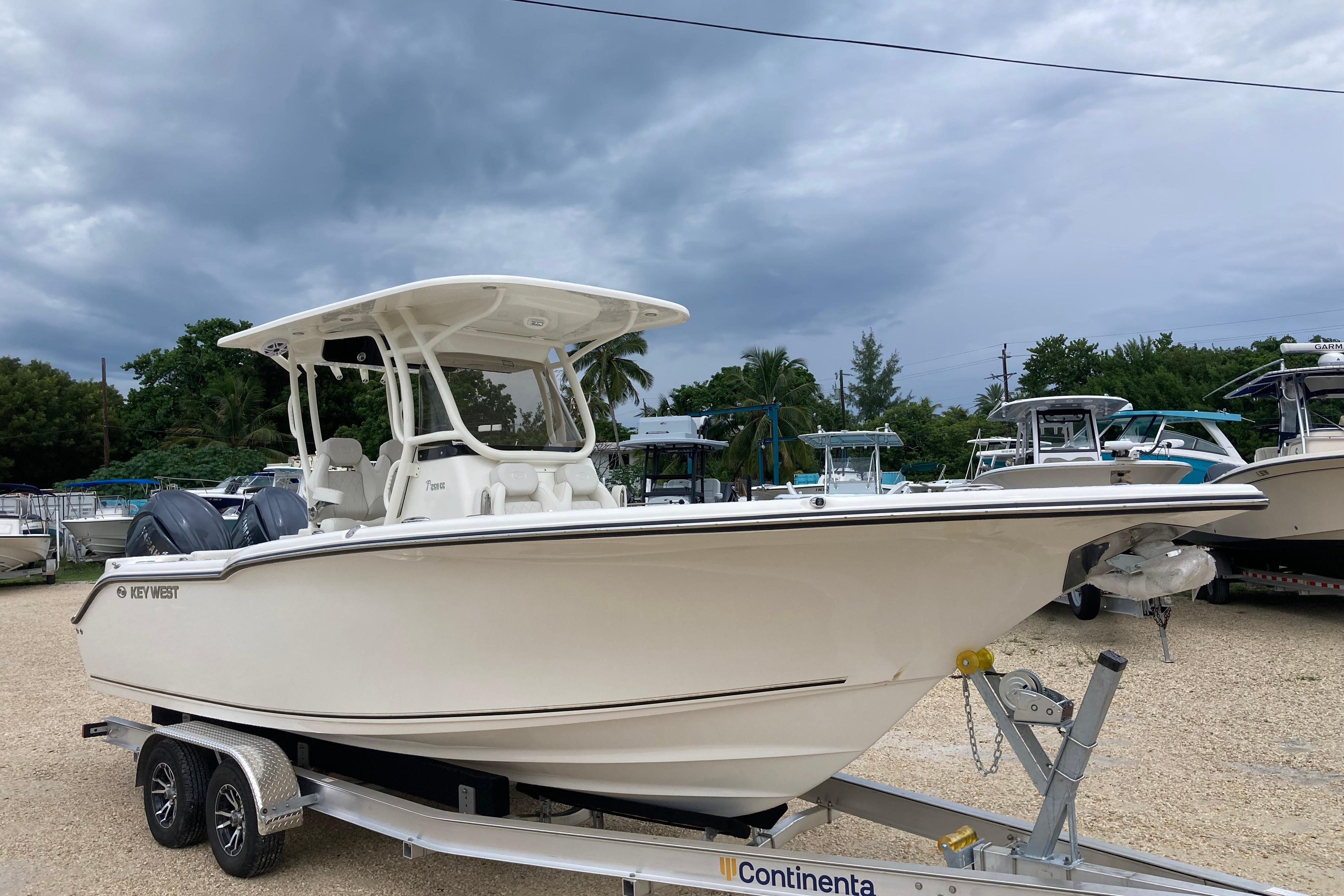 Key West 260 Center Console 2026 Key West 260 Center Console boat on trailer under cloudy sky.