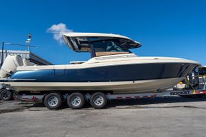 Chris-Craft Calypso 35 2026 Chris-Craft Calypso 35 boat on trailer under clear blue sky.