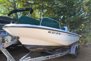 Boston Whaler 180 Dauntless 2002 Boston Whaler 180 Dauntless boat on trailer, covered, in wooded area.