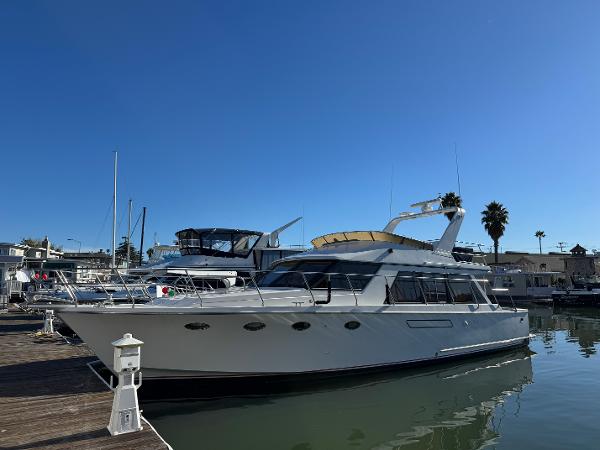 Ocean Alexander 46 1991 Ocean Alexander 46 yacht docked in a marina under clear blue skies.