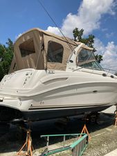 Sea Ray Sundancer 2004 Sea Ray Sundancer boat on stands under a clear blue sky.