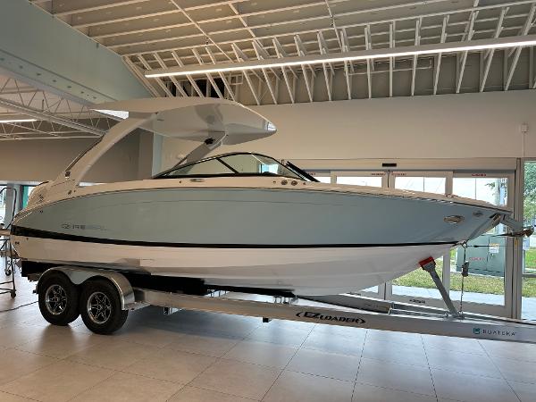 Regal LX6 2025 Regal LX6 boat on trailer in showroom, sleek design, modern features.