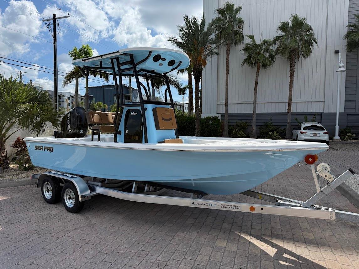 Sea Pro 210 Bay 2026 Sea Pro 210 Bay boat on trailer, parked outdoors with palm trees in background.