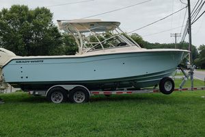 Grady-White Freedom 275 2025 Grady-White Freedom 275 boat on trailer, parked on grass beside road.