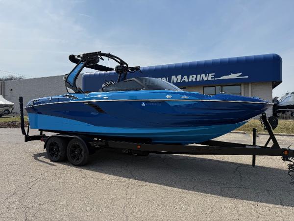 Centurion Fi23 2022 Centurion Fi23 boat in blue on a trailer outside a marine dealership.