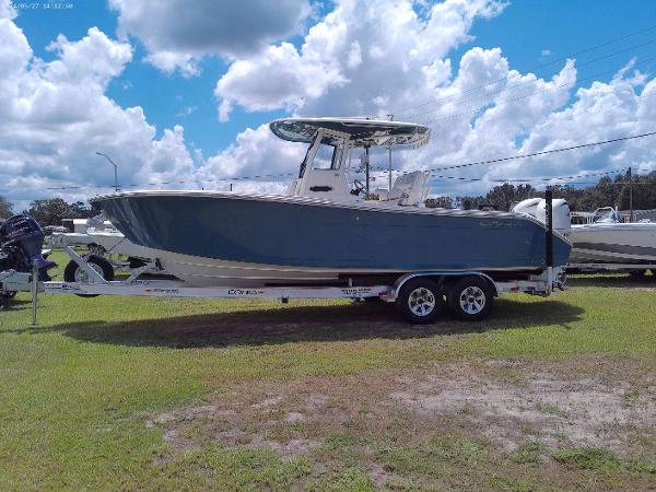 Cobia 265 Center Console 2025 Cobia 265 Center Console boat on trailer under cloudy sky.
