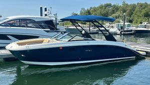Sea Ray SDX 270 2021 Sea Ray SDX 270 boat docked in a marina, featuring a sleek blue design.