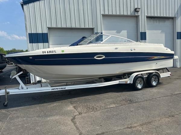 Bayliner 249 Sun Deck 2005 Bayliner 249SD boat on trailer, parked outside a garage.