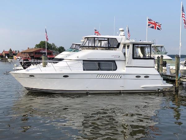 Carver 456 Aft Cabin Motor Yacht 2000 Carver 456 Aft Cabin Motor Yacht docked with flags in background.