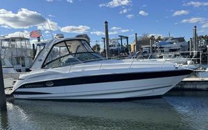 Monterey 335 Sport Yacht 2018 Monterey 335 SY boat docked in marina under blue sky.