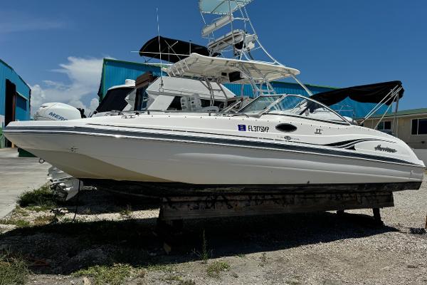 Hurricane Sun Deck 237 2004 Hurricane SUN DECK 237 boat on dry dock, white exterior, clear sky background.