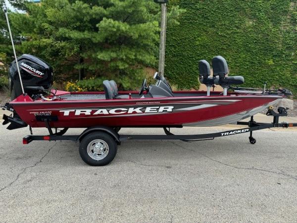 Tracker Pro Team 175 Crappie Edition 2025 Tracker Pro Team 175 Crappie Edition boat, red, on trailer, parked outdoors.